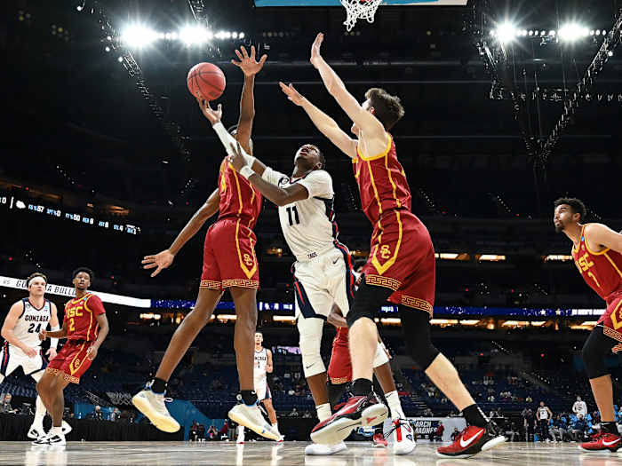 Gonzaga's Joel Ayayi shoots between two USC defenders